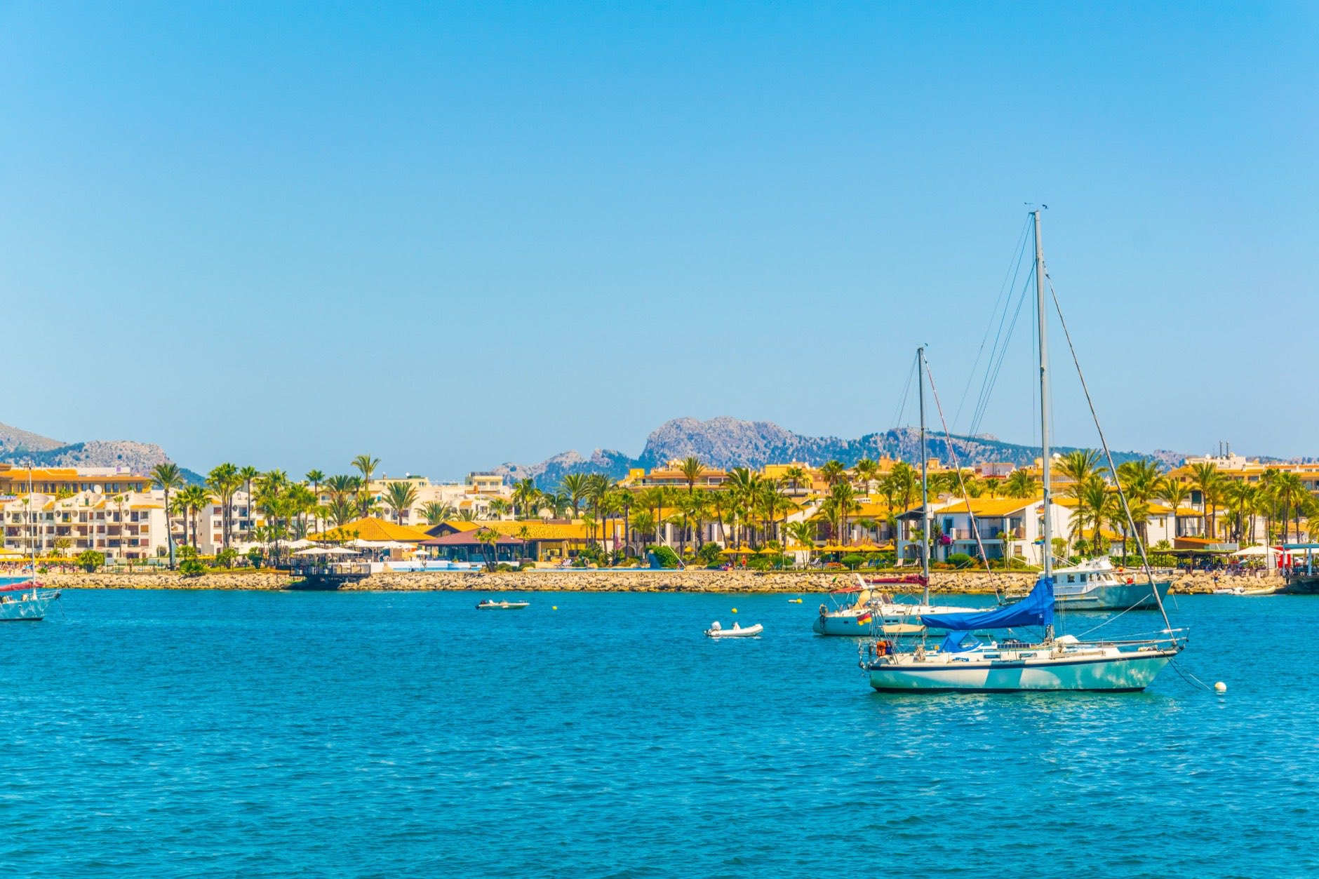 Holiday resorts stretched alongside Alcudia beach on Mallorca, Spai