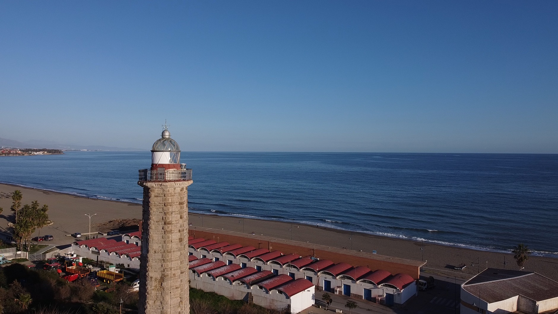 A view of the Estepona lighthouse and beach, ideal for travel and tourism visuals.
