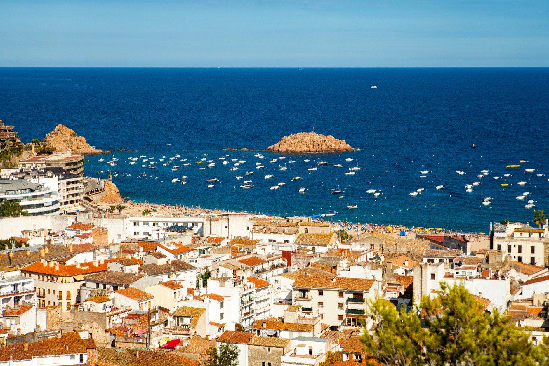 View of the town of Tossa de mar, city on the Costa Brava. Buildings and hotels on the hill. city in Girona, architecture and beach of Catalonia.