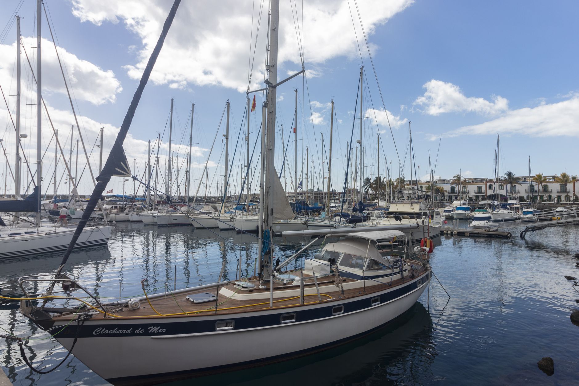 Captivating view of yachts docked in Mogán harbor under a bright, clear sky.