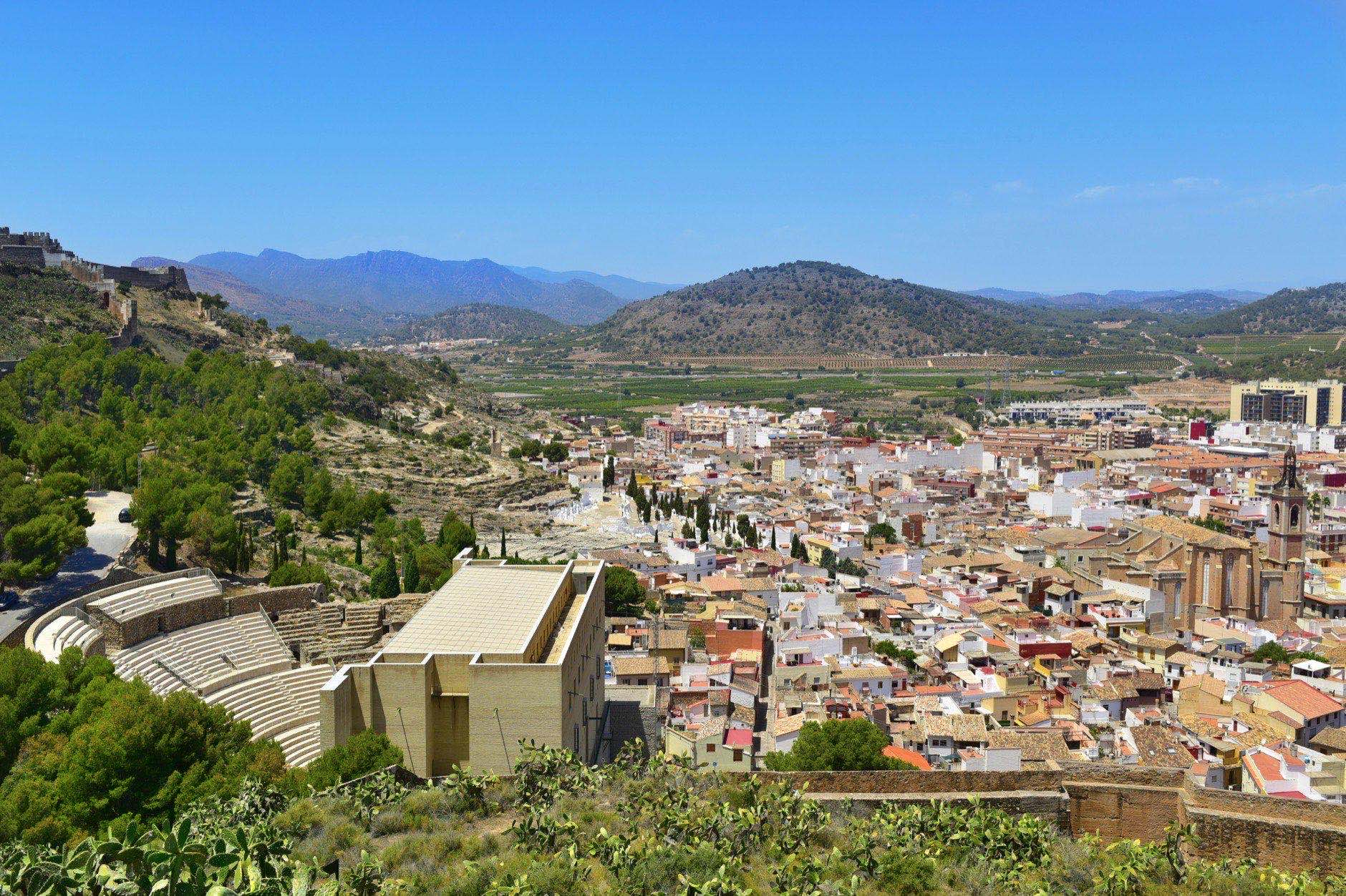 An aerial view of Sagunto, Spain, highlighting the ancient roman theater to the left and the Iglesia de Santa Maria church to the right