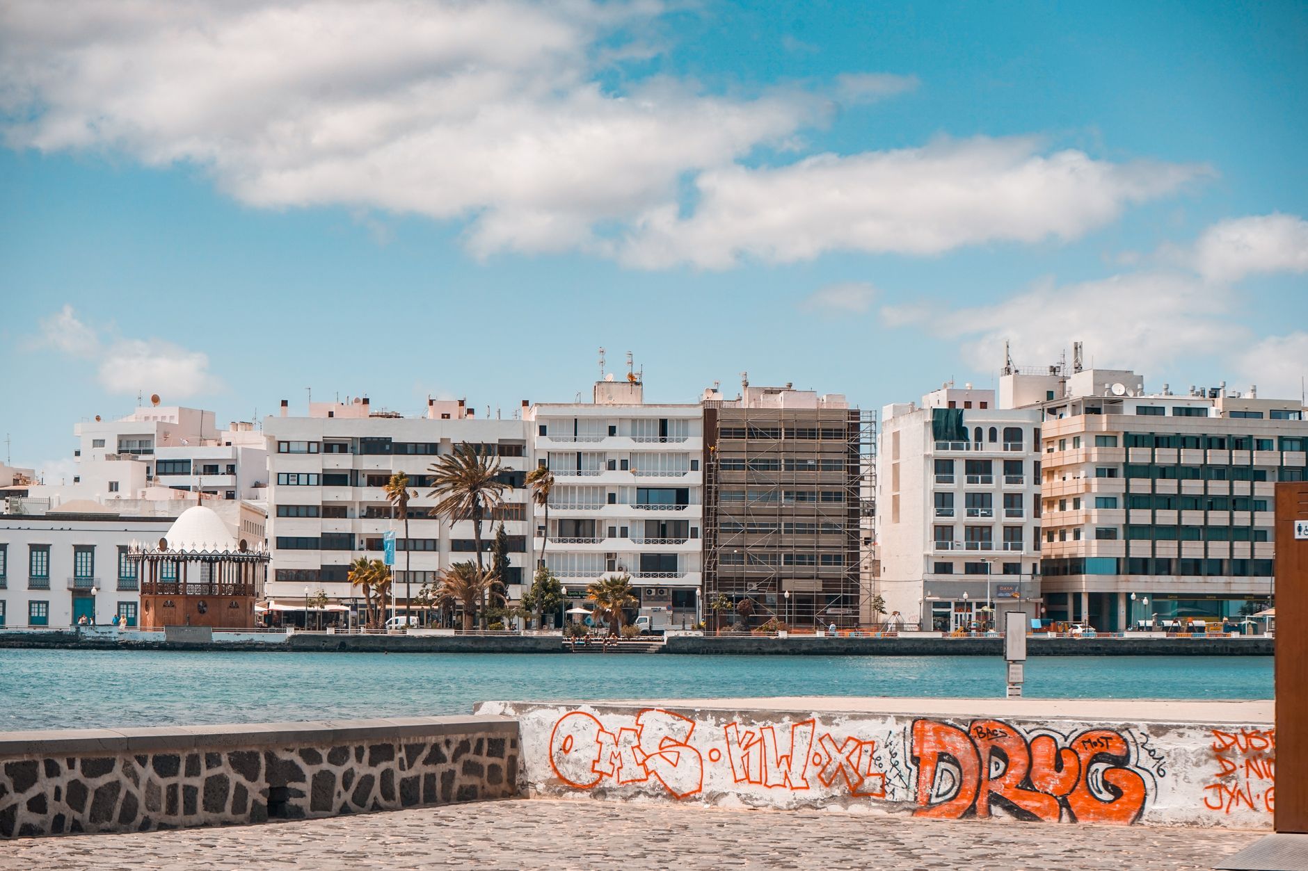 Puerto del Carmen in the municipality of Tías, Lanzarote, Spain — waterfront of Puerto del Carmen, Spain with buildings and graff